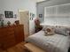 Bright bedroom features hardwood floors, light-blue colored walls, and natural light at 817 Tallgrass Ln, Bradenton, FL 34212