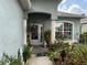 Inviting front porch with decorative plants and a charming welcome mat, great curb appeal at 817 Tallgrass Ln, Bradenton, FL 34212