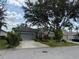Charming single-story home with lush landscaping and a large shade tree in the front yard at 817 Tallgrass Ln, Bradenton, FL 34212