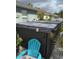 Outdoor hot tub with a gray cover and a blue chair nearby at 817 Tallgrass Ln, Bradenton, FL 34212