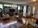 This living room features plenty of seating, hardwood floors, and plenty of natural light at 817 Tallgrass Ln, Bradenton, FL 34212