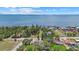 An aerial view of a waterfront community featuring lush trees at 8255 Longbay Blvd, Sarasota, FL 34243