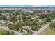 Aerial view of a home with landscaping and a nearby airport at 8255 Longbay Blvd, Sarasota, FL 34243