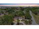 Aerial view of a home with a private pool surrounded by lush greenery and mature trees at 8255 Longbay Blvd, Sarasota, FL 34243