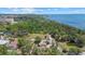 Aerial view of a property on a waterfront with lush trees at 8255 Longbay Blvd, Sarasota, FL 34243