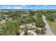 Overhead view of a wooded property featuring a swimming pool and landscaping at 8255 Longbay Blvd, Sarasota, FL 34243