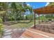 Backyard featuring a wooden deck and large yard with surrounding foliage and trees at 8255 Longbay Blvd, Sarasota, FL 34243
