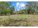 Extensive yard featuring mature trees, a shed, pool, and the home in the background at 8255 Longbay Blvd, Sarasota, FL 34243