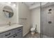 Updated bathroom features a shower and modern vanity with granite countertop at 8255 Longbay Blvd, Sarasota, FL 34243