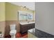 Cozy bathroom featuring wood cabinets, a marble countertop, and a toilet at 8255 Longbay Blvd, Sarasota, FL 34243
