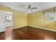 Bright bedroom with hardwood floors, ceiling fan, and window overlooking the yard at 8255 Longbay Blvd, Sarasota, FL 34243