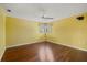 Spacious bedroom with hardwood floors, ceiling fan, and large windows at 8255 Longbay Blvd, Sarasota, FL 34243