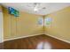 Bedroom with hardwood floors, bright yellow walls and two large windows at 8255 Longbay Blvd, Sarasota, FL 34243
