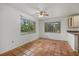 Bright dining area with terra cotta floors and views of the lush outdoor greenery at 8255 Longbay Blvd, Sarasota, FL 34243