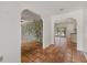 Open-concept hallway with stone accent wall leading to the outdoor pool area at 8255 Longbay Blvd, Sarasota, FL 34243