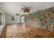 Spacious living room with terra cotta floors, stone accent wall, and natural lighting at 8255 Longbay Blvd, Sarasota, FL 34243