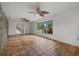 Bright living room with terra cotta floors and a large window with views of the outdoors at 8255 Longbay Blvd, Sarasota, FL 34243