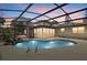 Inviting backyard pool with screened enclosure and waterfall feature at 8255 Longbay Blvd, Sarasota, FL 34243