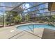 Inviting backyard pool with screened enclosure and lush landscaping at 8255 Longbay Blvd, Sarasota, FL 34243