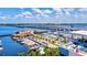 Aerial view showcasing a marina filled with boats along the beautiful blue ocean and a bridge in the distance at 8272 Redonda Loop, Bradenton, FL 34202