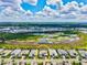 Beautiful aerial view of a home with a paver driveway in a lush community with a lake at 8272 Redonda Loop, Bradenton, FL 34202