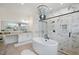 Elegant bathroom featuring a soaking tub, a glass shower, and dual vanity sinks at 8272 Redonda Loop, Bradenton, FL 34202