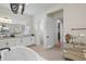 Bright bathroom with white cabinets, granite countertop and walk-in closet at 8272 Redonda Loop, Bradenton, FL 34202
