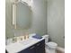 Stylish powder room with patterned wallpaper, a modern sink, and gold accents at 8272 Redonda Loop, Bradenton, FL 34202