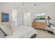 Bright bedroom with a ceiling fan, large window, and a wooden dresser at 8272 Redonda Loop, Bradenton, FL 34202
