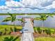 Picturesque pier view with a water fountain, palm trees and tranquil water views at 8272 Redonda Loop, Bradenton, FL 34202