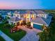 Elegant home with lush landscaping, paver driveway, and attached three car garage at 8272 Redonda Loop, Bradenton, FL 34202