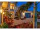 Charming home showcasing lush landscaping, a paver driveway, and an inviting entrance at 8272 Redonda Loop, Bradenton, FL 34202