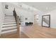 Bright two-story foyer with a wooden staircase and seating area at 8272 Redonda Loop, Bradenton, FL 34202