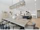 Open kitchen with an island featuring bar seating and modern stainless steel appliances at 8272 Redonda Loop, Bradenton, FL 34202