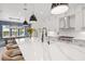 Bright open kitchen with a large center island and a dining area with modern pendant lighting at 8272 Redonda Loop, Bradenton, FL 34202