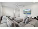 Spacious living room with a plush sectional sofa, ceiling fan, and a mounted television at 8272 Redonda Loop, Bradenton, FL 34202