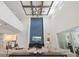 Open living room featuring high ceilings, a blue accent wall, modern decor and backyard access at 8272 Redonda Loop, Bradenton, FL 34202