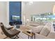 Open living room featuring high ceilings, a blue accent wall, and comfortable modern furnishings at 8272 Redonda Loop, Bradenton, FL 34202