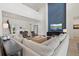 Bright living room with soaring ceilings, modern furniture, and accent wall at 8272 Redonda Loop, Bradenton, FL 34202