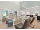Open-concept living room with high ceilings, access to the backyard and a modern kitchen at 8272 Redonda Loop, Bradenton, FL 34202
