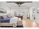 Bright main bedroom with a ceiling fan, tray ceiling, and a door to the outdoor area at 8272 Redonda Loop, Bradenton, FL 34202