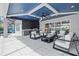 Inviting outdoor patio with a well-equipped kitchen, cozy seating, and elegant design at 8272 Redonda Loop, Bradenton, FL 34202