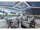 Wonderful patio with modern furniture, beautiful swimming pool, and covered outdoor kitchen at 8272 Redonda Loop, Bradenton, FL 34202