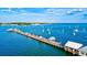 Scenic view of a pier extending into the ocean, surrounded by sail boats in the open water under a blue sky at 8272 Redonda Loop, Bradenton, FL 34202