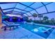 Inviting screened-in pool with integrated loungers, water features, and spacious marble tiling at 8272 Redonda Loop, Bradenton, FL 34202