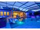 Outdoor pool features decorative lighting, an integrated lounge area, and an enclosed sunroom at 8272 Redonda Loop, Bradenton, FL 34202