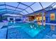 Gorgeous screened-in pool featuring ample seating, water features, and beautiful tiling and hardscaping at 8272 Redonda Loop, Bradenton, FL 34202
