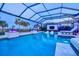 Enjoy evening swims in this caged pool with in-pool loungers, water features, lush landscaping, and outdoor seating at 8272 Redonda Loop, Bradenton, FL 34202