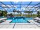 Beautiful screened in pool area with luxurious lounge seating and outdoor shower features at 8272 Redonda Loop, Bradenton, FL 34202
