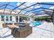 Covered outdoor pool showcasing stylish patio furniture and a spacious lounge area for relaxation at 8272 Redonda Loop, Bradenton, FL 34202